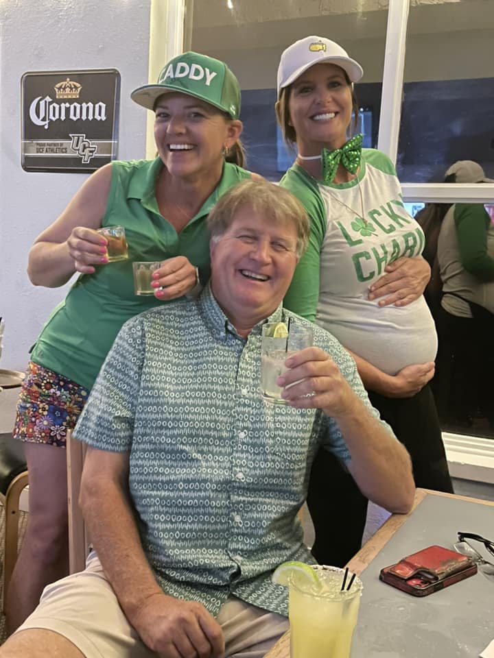 2 girls and a guy smiling for the camera in St. Patrick's day attire