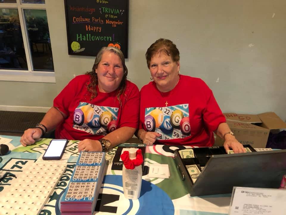 2 girls in red t shirts smile for the camera